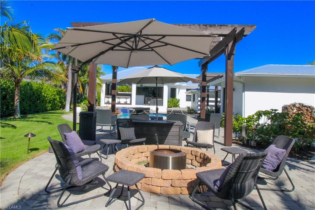 View of patio with a fire pit