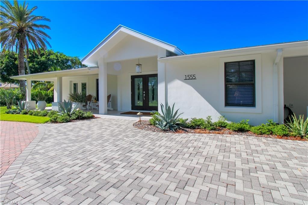 Property entrance with a porch and french doors