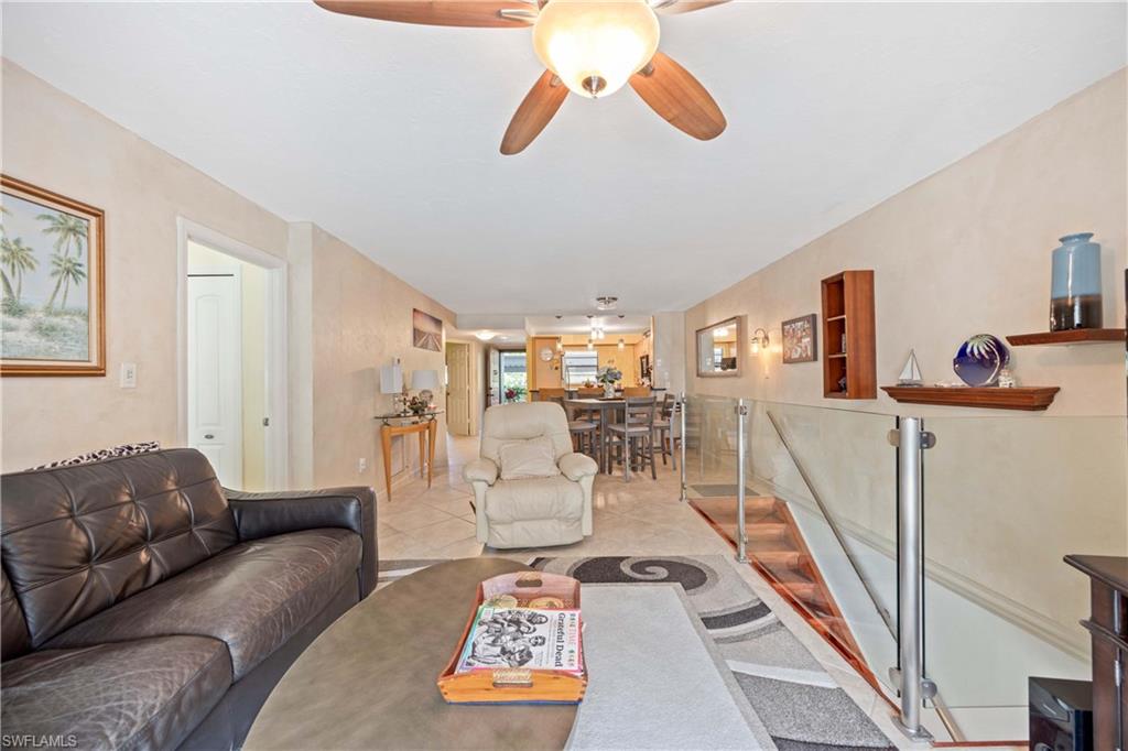 Tiled living room featuring ceiling fan