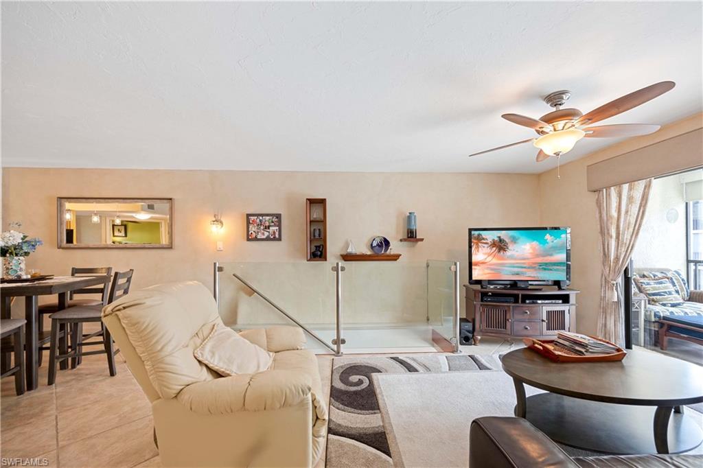 Tiled living room featuring ceiling fan