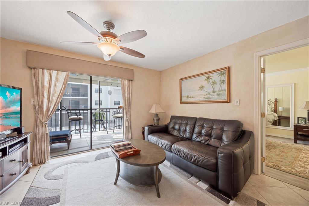 Living room featuring ceiling fan and light tile patterned floors