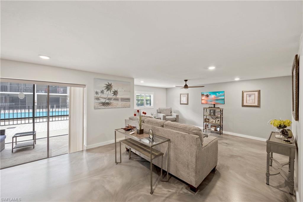 Living room featuring ceiling fan and plenty of natural light