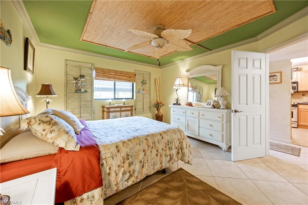 Tiled bedroom with ceiling fan, wooden ceiling, and ornamental molding