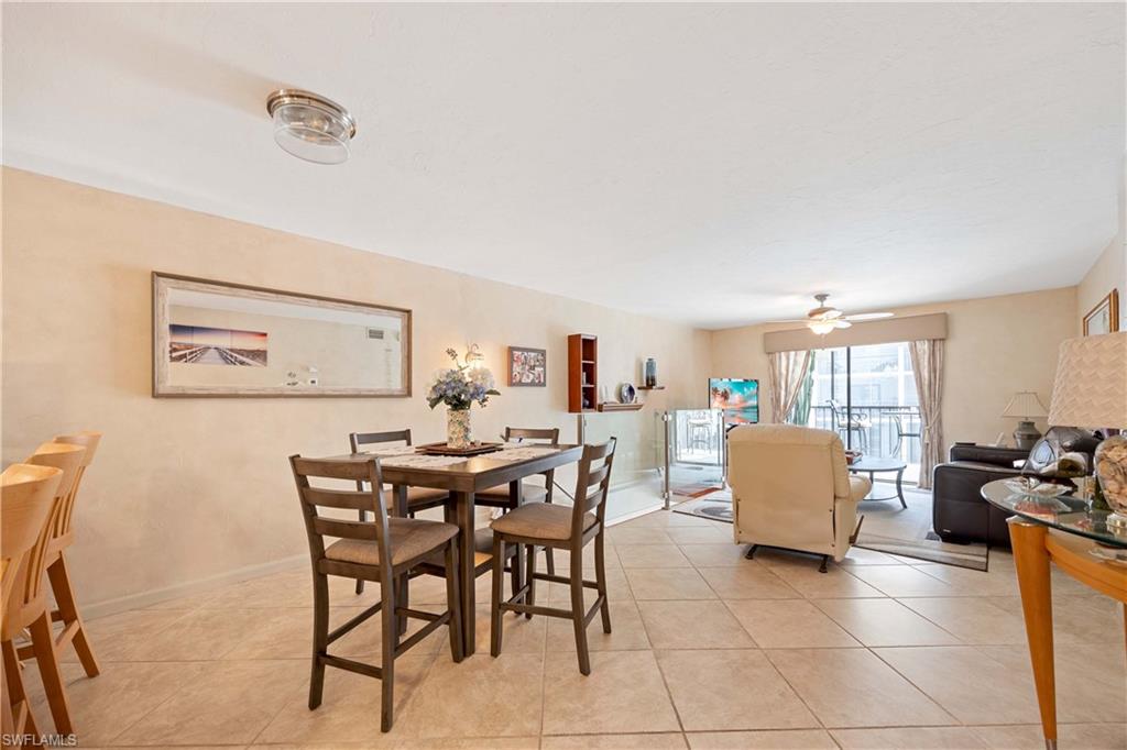 Tiled dining room with ceiling fan