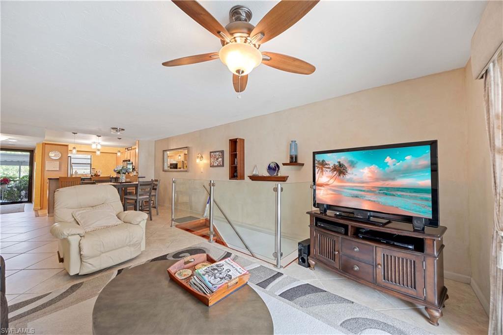 Living room featuring ceiling fan and light tile patterned floors