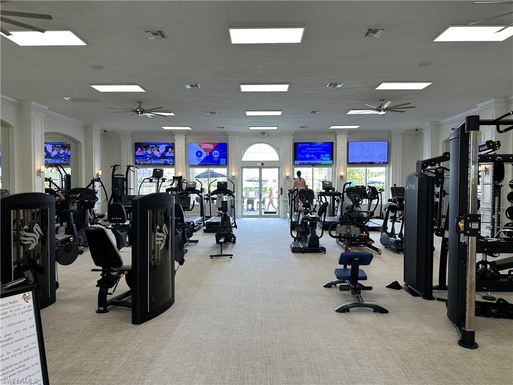 Gym featuring ceiling fan, visible vents, and ornamental molding