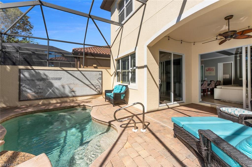 Outdoor pool with a lanai, a ceiling fan, and a patio area
