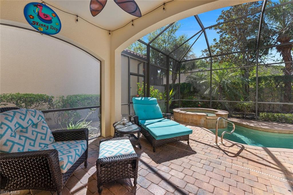 Sunroom with a ceiling fan and a hot tub
