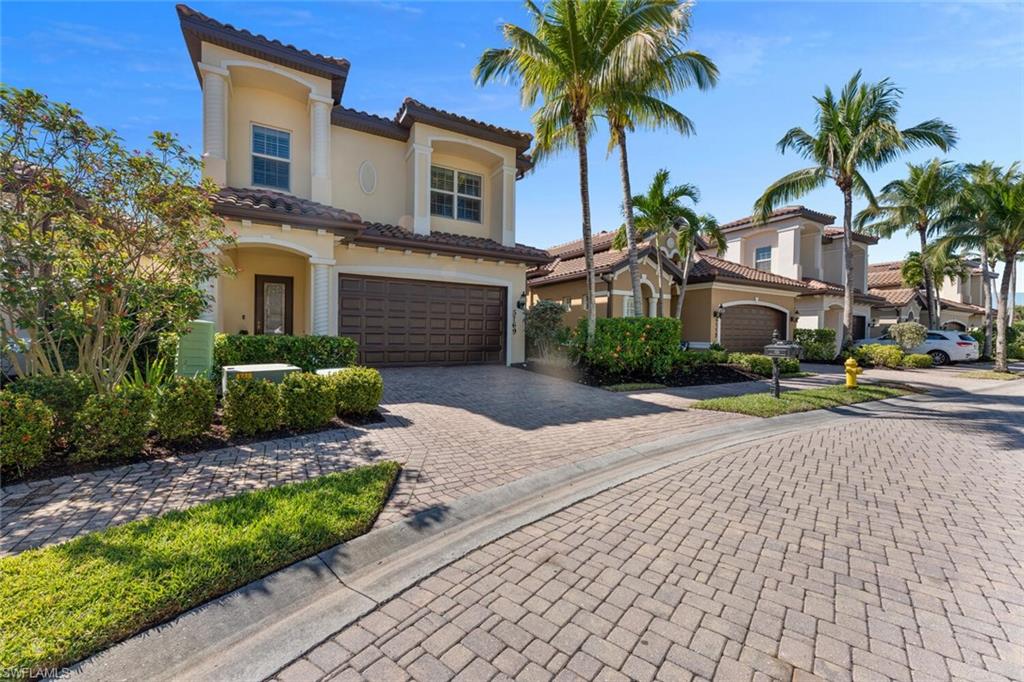 Mediterranean / spanish home with stucco siding, decorative driveway, and a tile roof