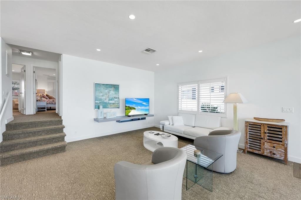 Living room with carpet floors and recessed lighting