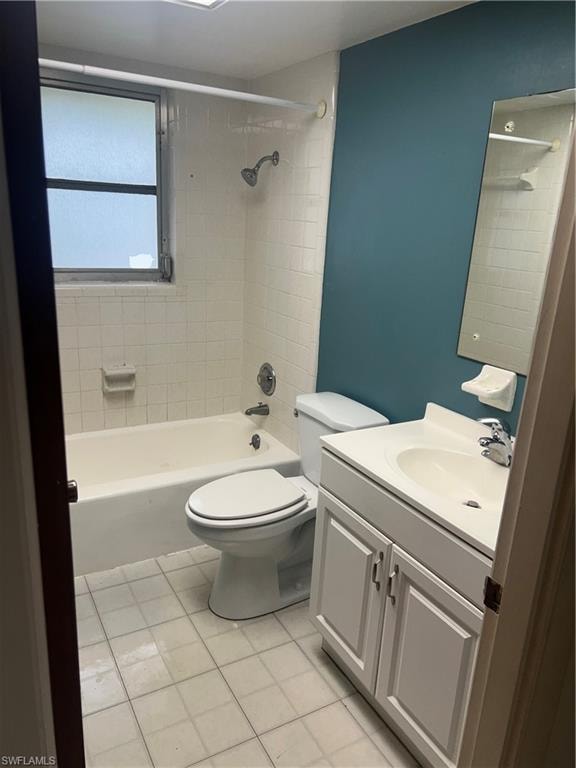 Bathroom featuring vanity, light tile patterned flooring, and tub / shower combination