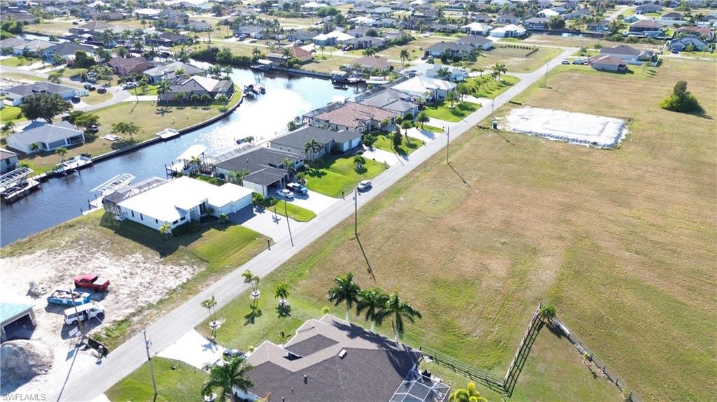 Aerial perspective of suburban area featuring a nearby body of water