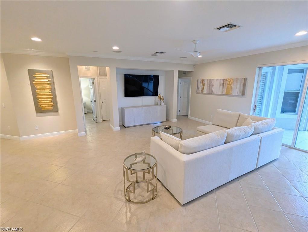 Living area featuring ornamental molding, recessed lighting, ceiling fan, and light tile patterned floors