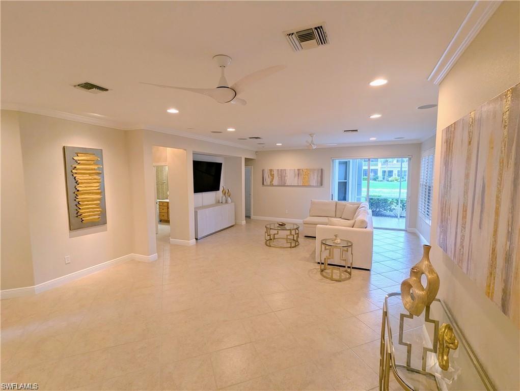 Living area with crown molding and recessed lighting