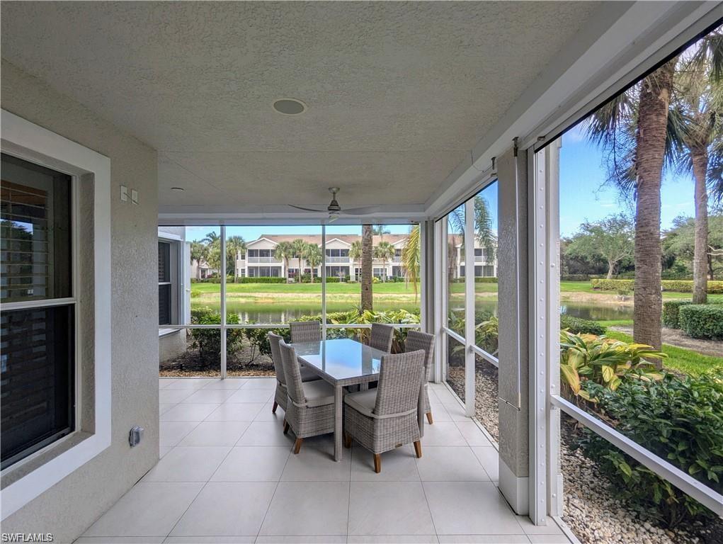 Sunroom / solarium with a water view and outdoor dining space