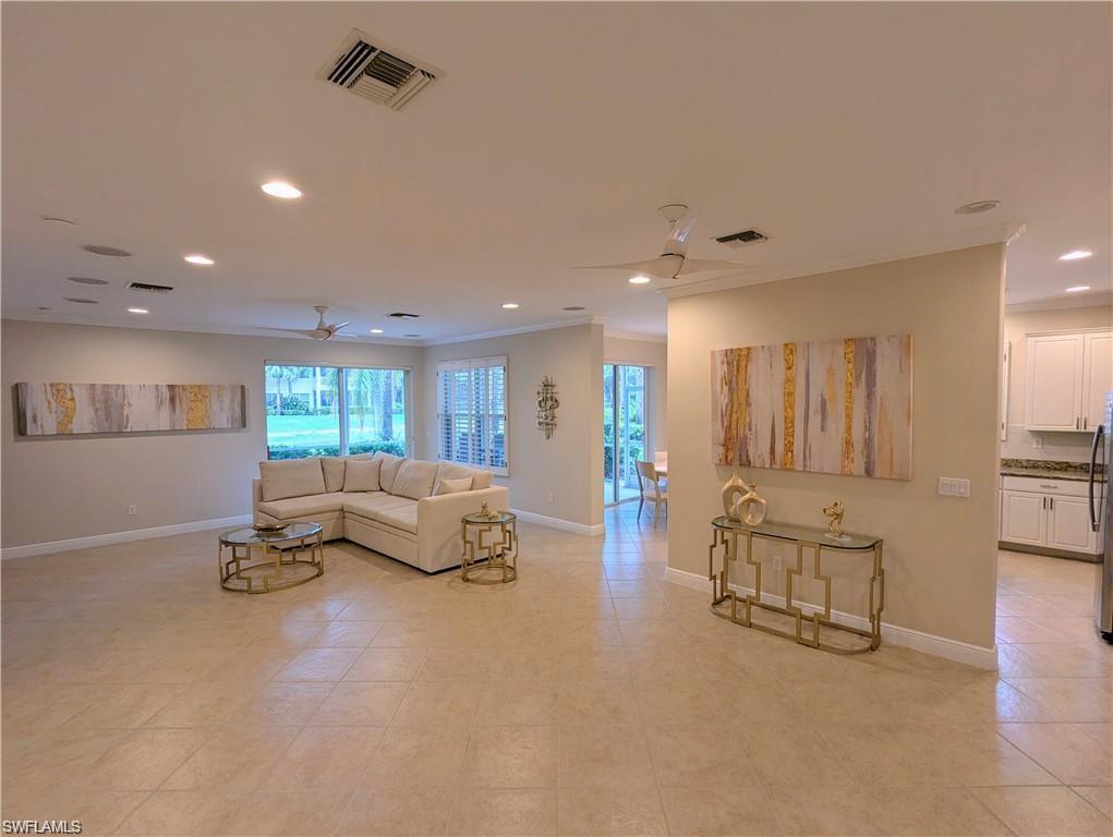 Living room with a ceiling fan, recessed lighting, and crown molding