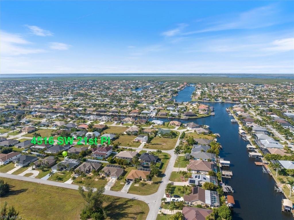 View of property location with a large body of water and nearby suburban area