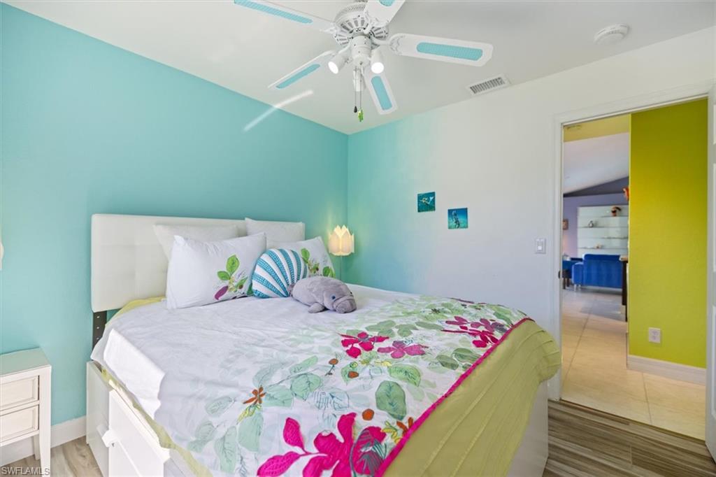 Bedroom with light wood finished floors and ceiling fan