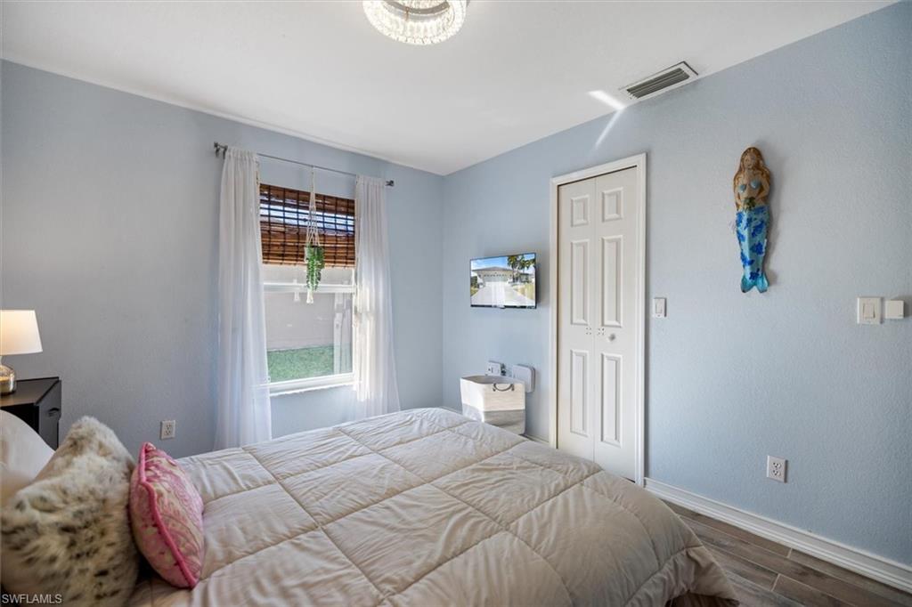 Bedroom featuring wood finished floors and a closet