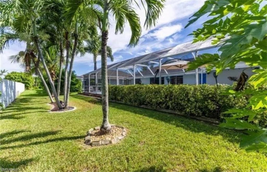 View of yard with a sunroom and a lanai