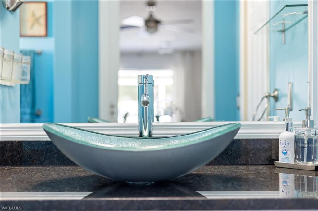 Bathroom view of vanity and a ceiling fan