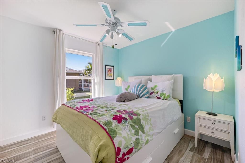 Bedroom featuring wood finished floors and a ceiling fan