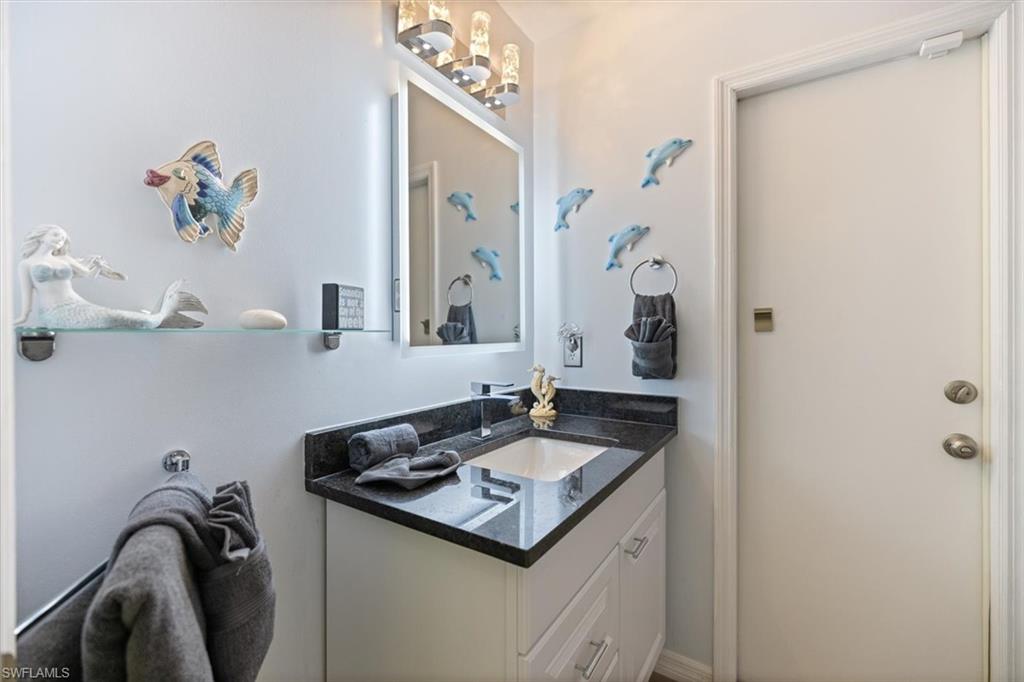 Bathroom featuring vanity and a chandelier