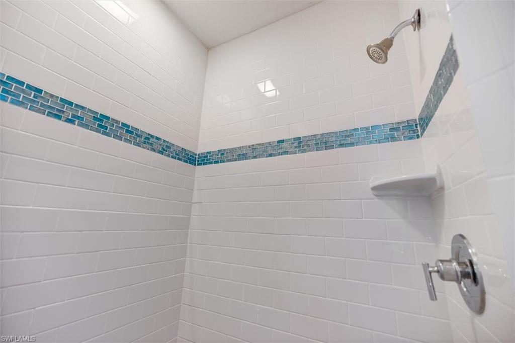 Bathroom view of a tile shower