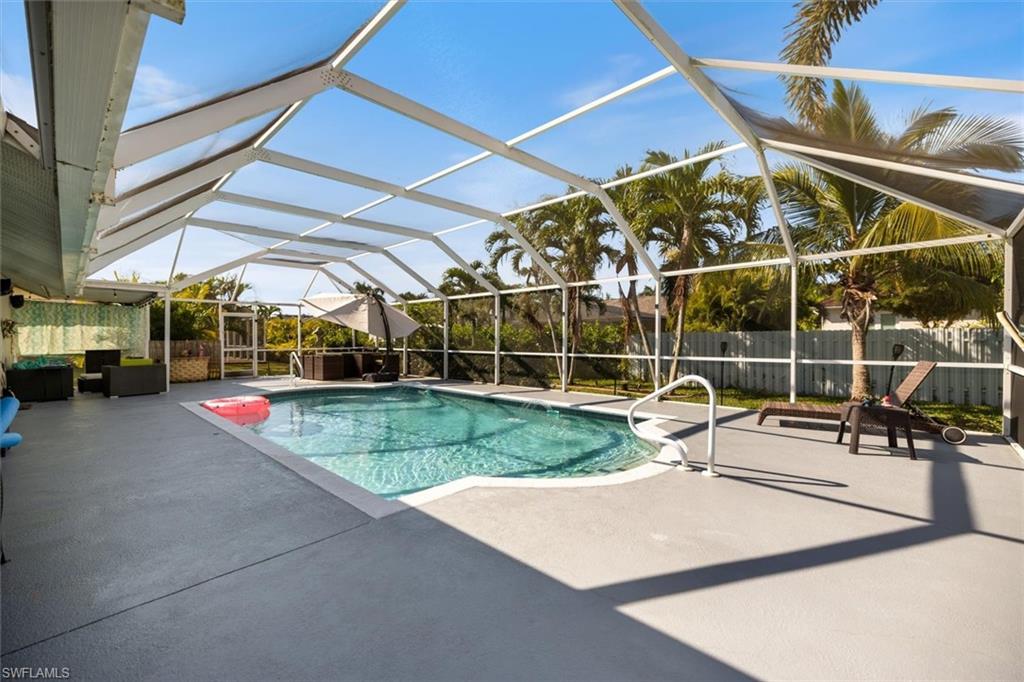 View of pool with a patio, glass enclosure, and a sunroom