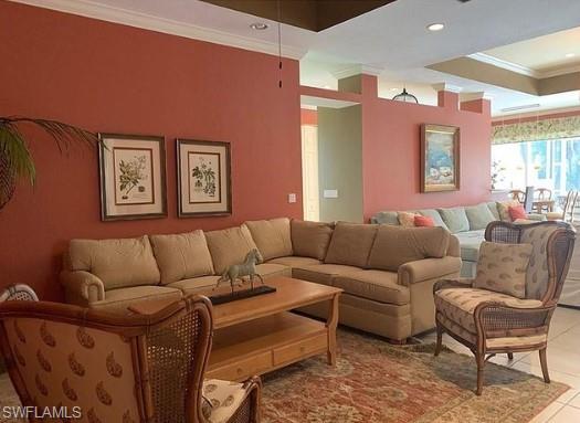 Living room featuring tile patterned flooring and crown molding