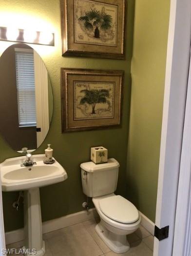 Bathroom with tile patterned flooring and toilet