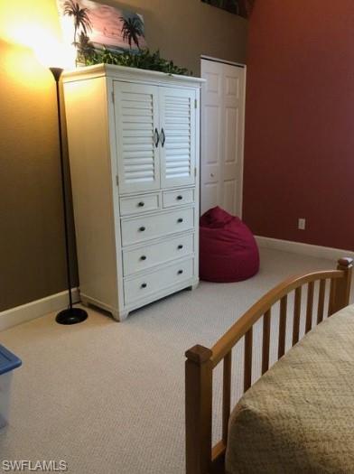 Carpeted bedroom featuring a closet