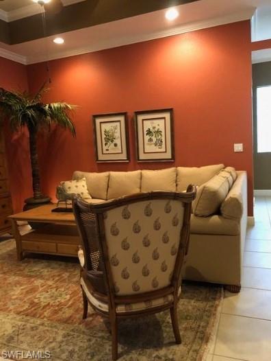 Sitting room with tile patterned flooring and crown molding