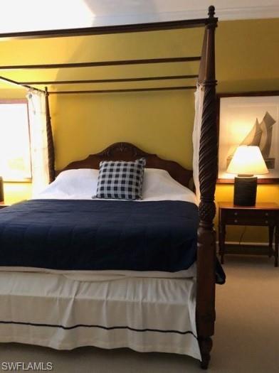 Bedroom featuring carpet floors and ornamental molding