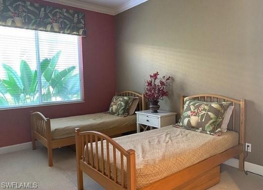 Carpeted bedroom with crown molding