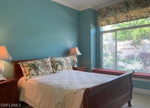 Bedroom with carpet flooring and crown molding