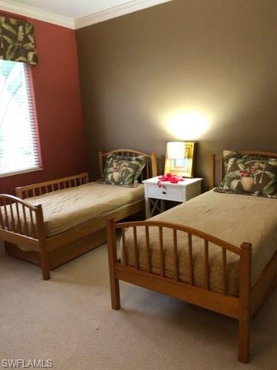 Bedroom with carpet flooring, radiator, and ornamental molding
