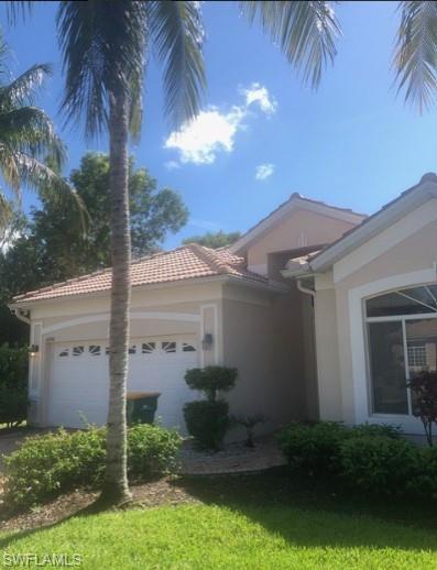 View of side of property with a garage