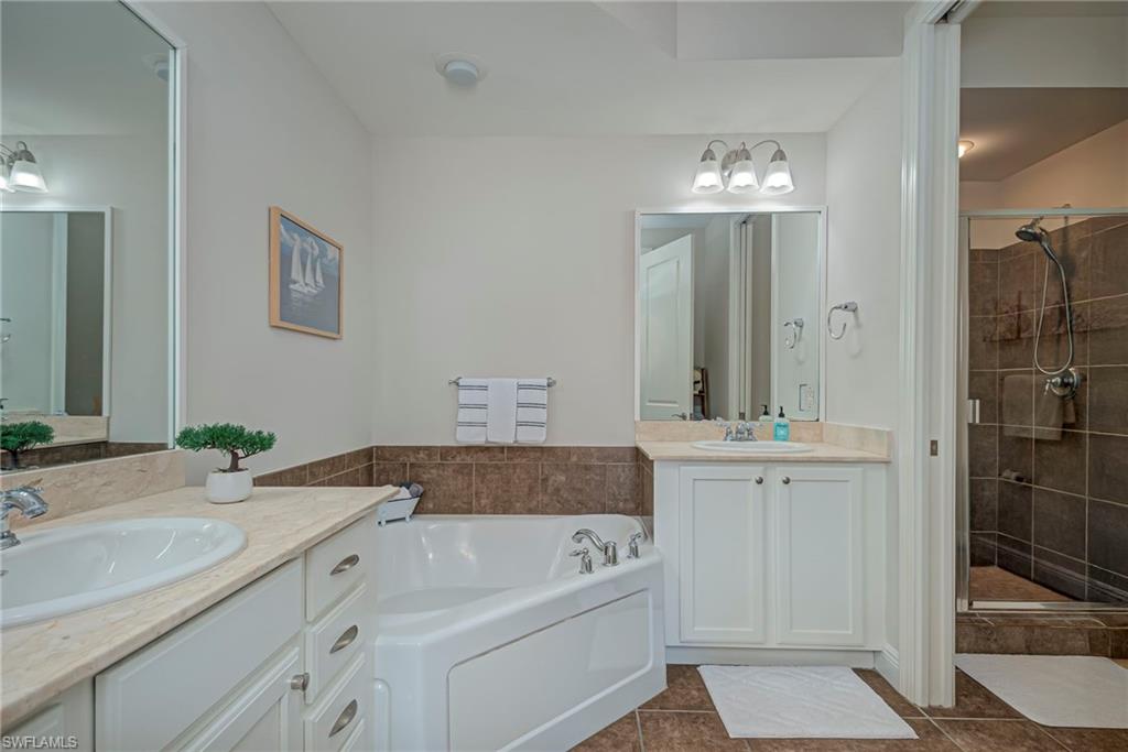 Primary bathroom has a soaking tub, double vanities, and shower