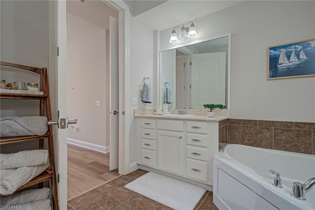 Primary bathroom has a soaking tub, double vanities, and shower