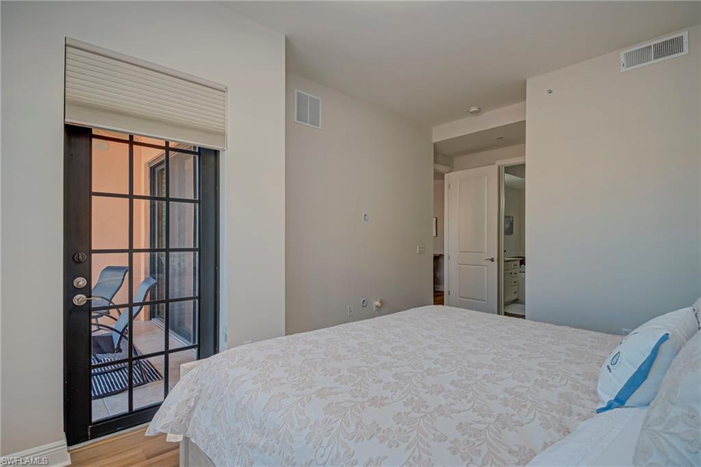 Primary bedroom has access to screened-in lanai and plenty of natural light, walk-in shower, and ensuite bathroom