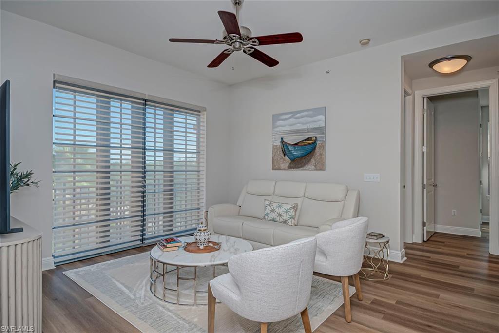 Living area featuring new floors and a ceiling fan