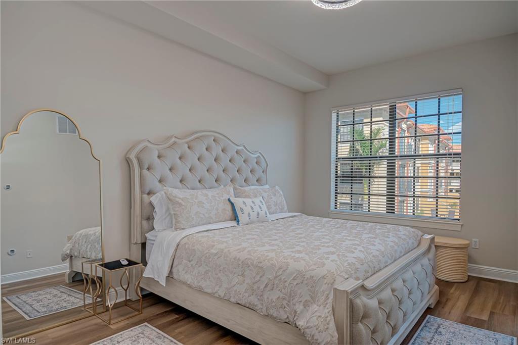 Primary bedroom has access to screened-in lanai and plenty of natural light, walk-in shower, and ensuite bathroom