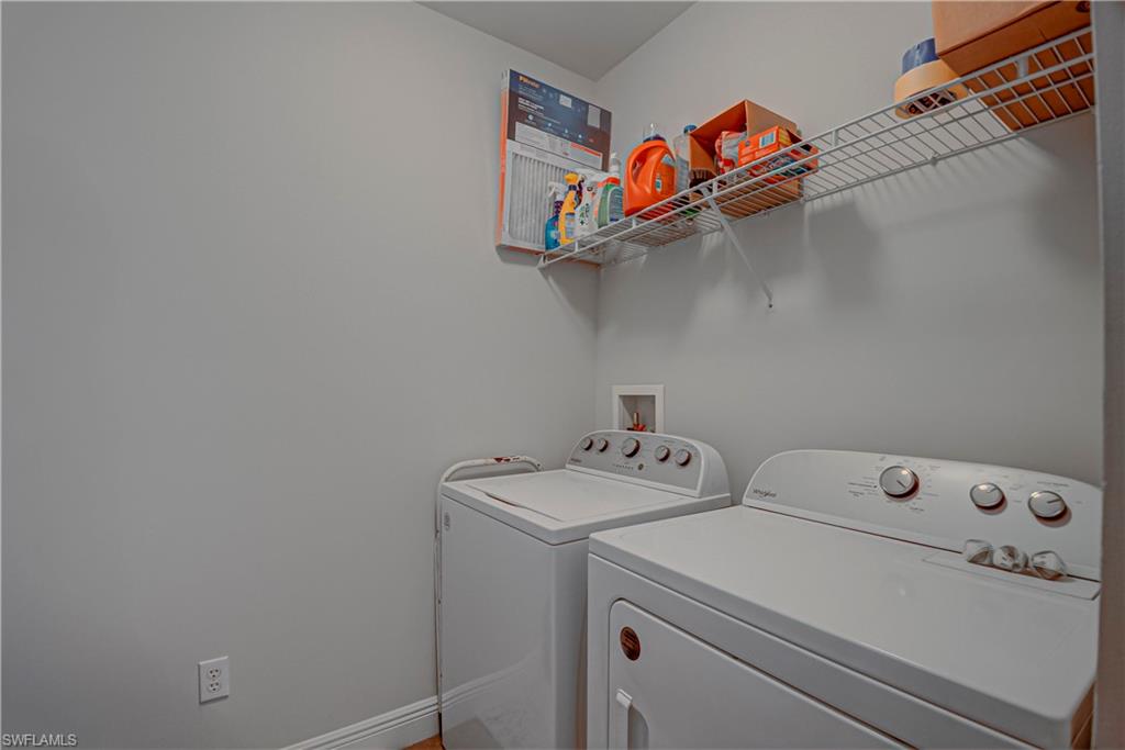 Washroom featuring baseboards and independent washer and dryer