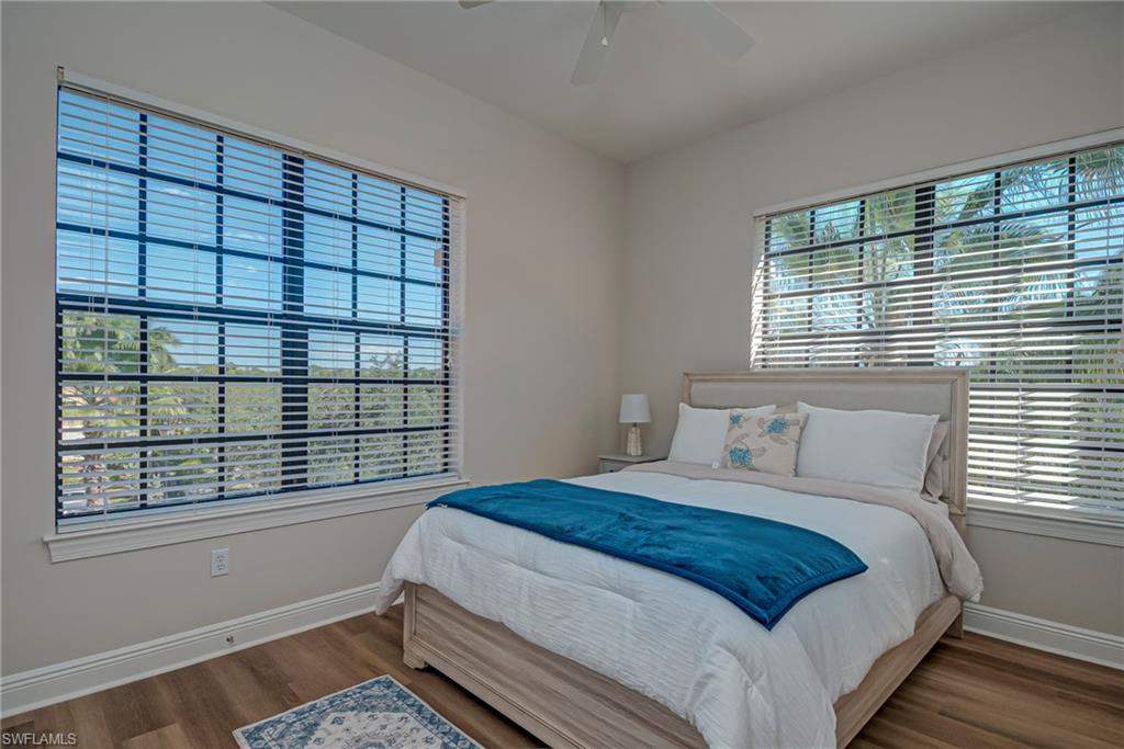 This bedroom is one of three and is bright and light with a queen bed