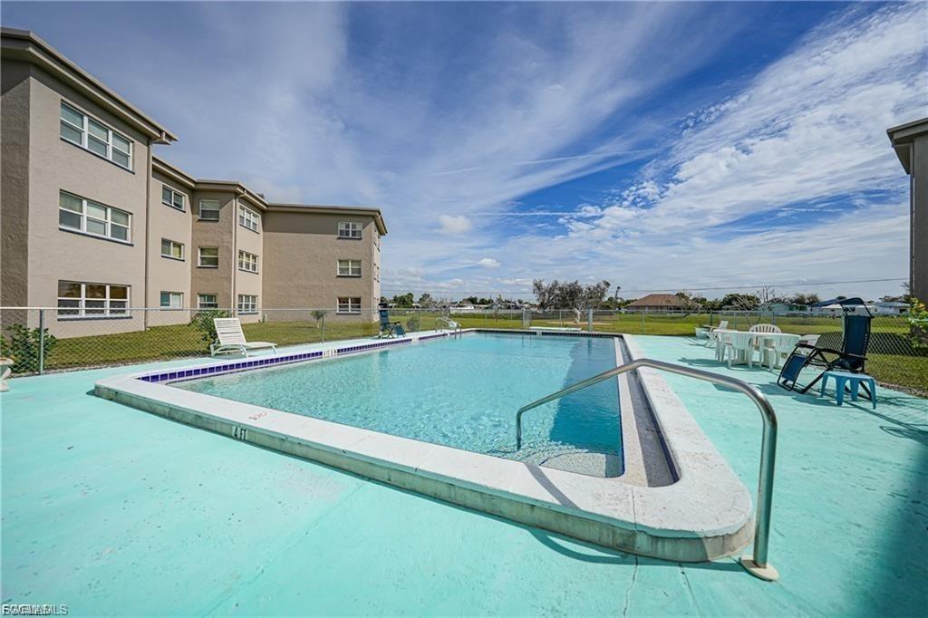 Community pool with a patio