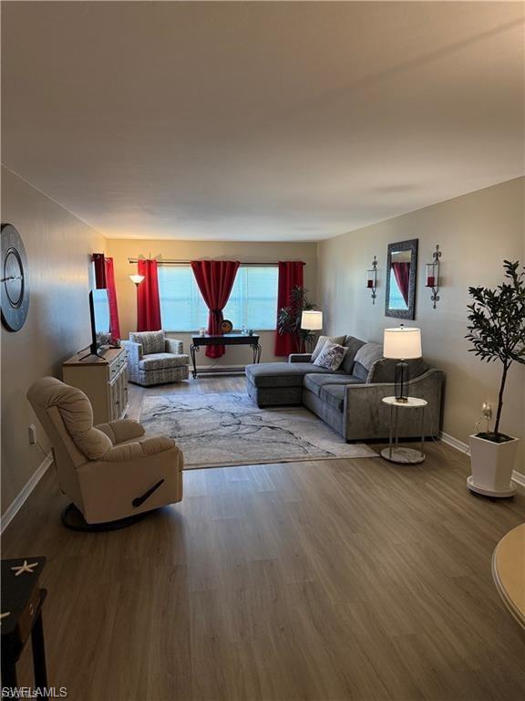 Living room with baseboards and wood finished floors