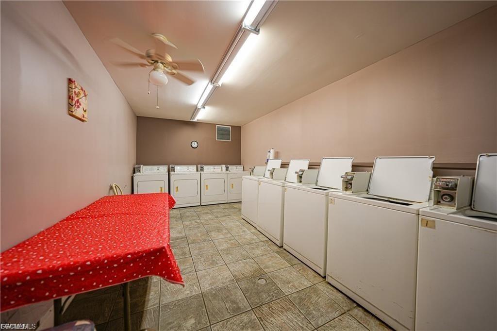 Shared laundry featuring washing machine and clothes dryer and a ceiling fan