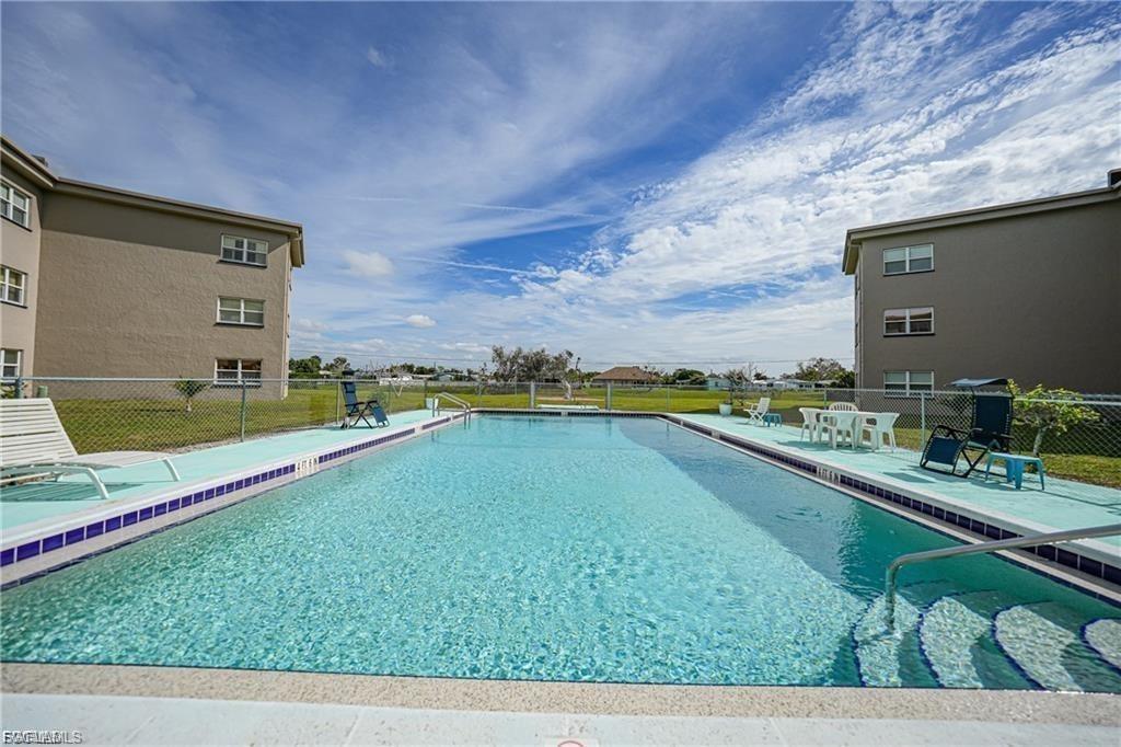 Community pool with a patio