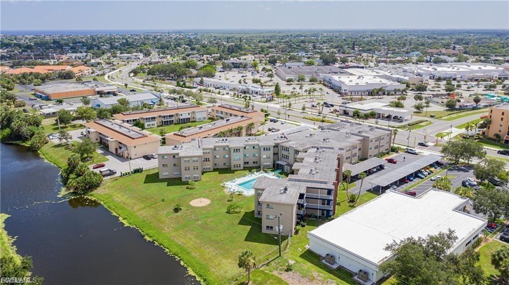 Bird's eye view of a nearby body of water and apartment complex / building